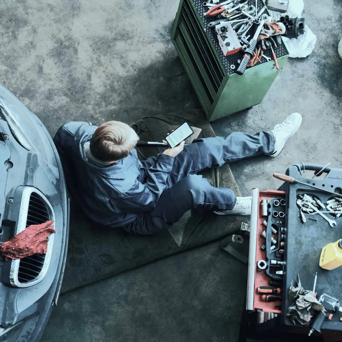 Top view of mechanic repairing car
